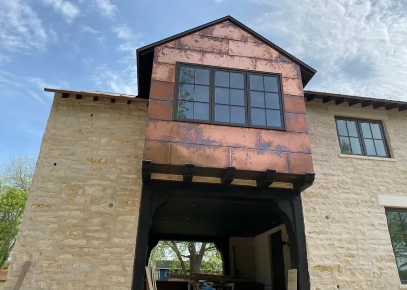 Copper metal panel facade on a stone building for Skylight Installation in Winter Haven