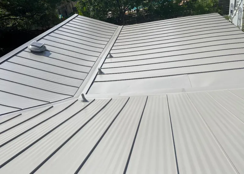 Solar attic fan installed on a metal roof for Roof Ventilation in Winter Haven